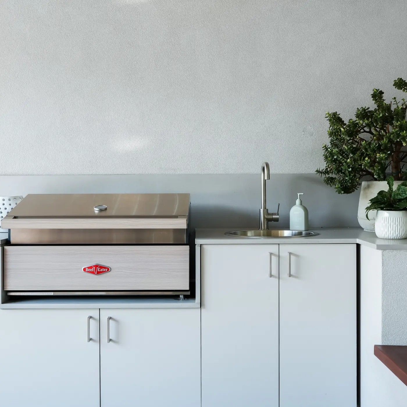Outdoor kitchen with a built-in barbecue, sink and rendered surround, Castlecrag