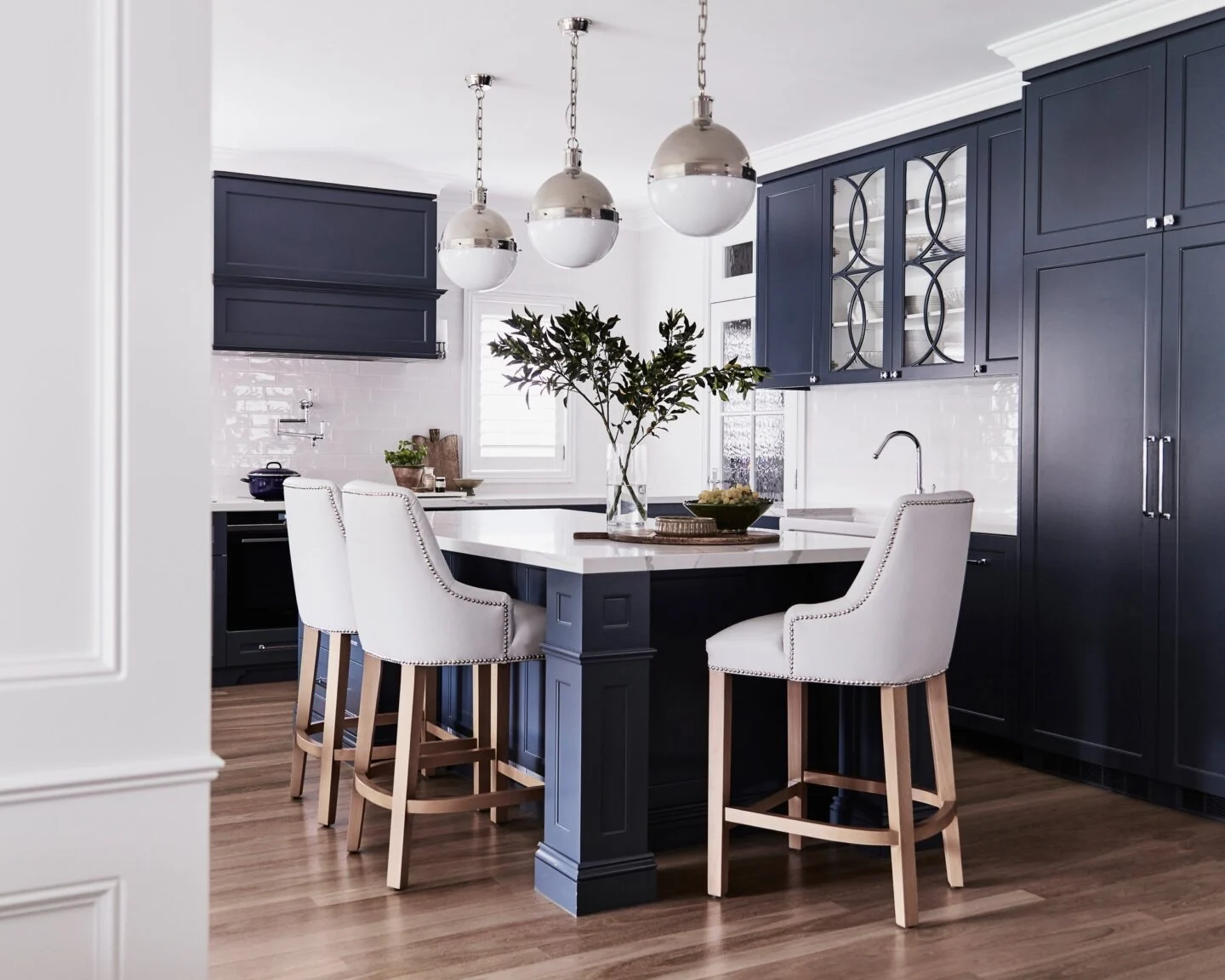Navy shaker kitchen with a stone island, glazed splashback and polished nickel pendants, Concord
