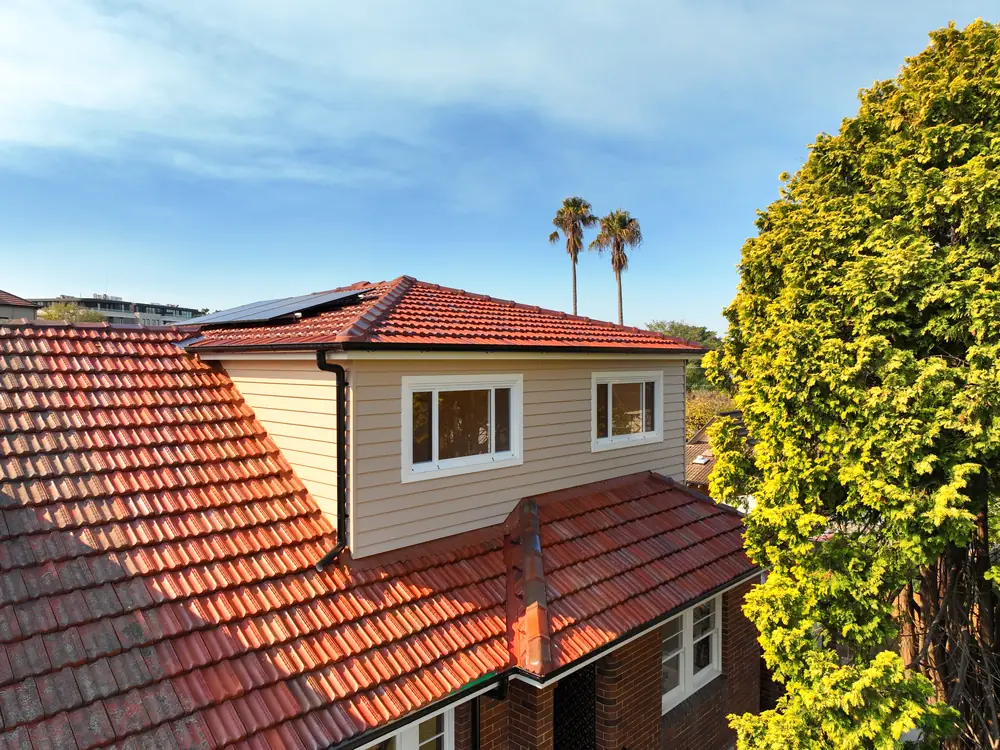 The completed top storey addition seen from the air, set among the street trees