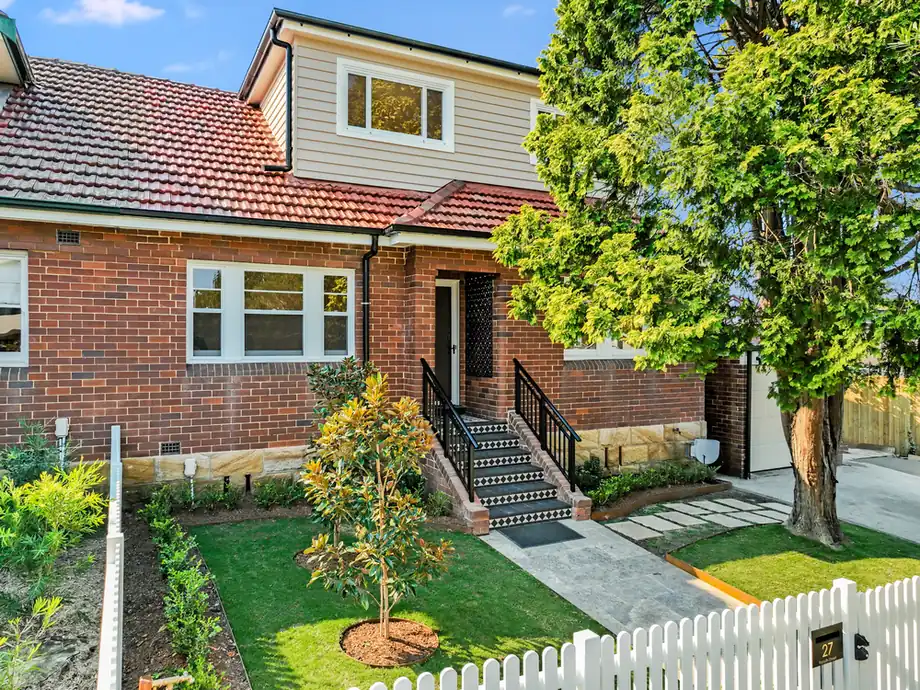 The front of the house after the addition, with new lawn and planting