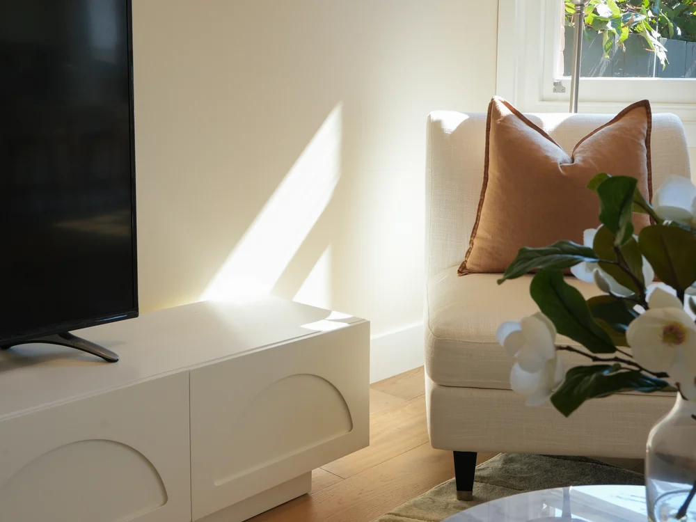 Living room with a linen sofa and boucle ottoman
