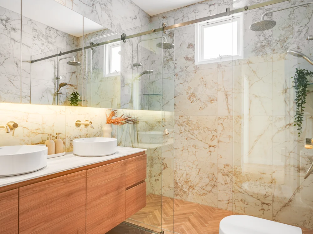 Bathroom lined in marble with a walk-in shower