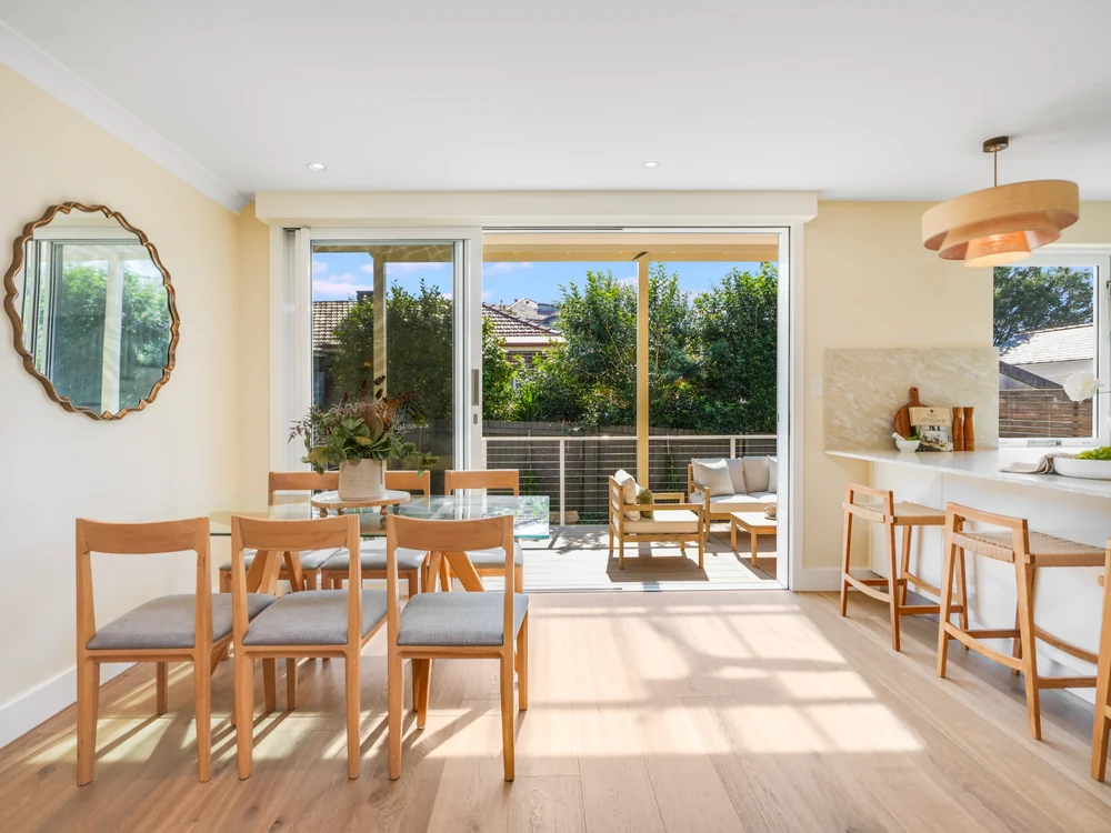 Dining area opening onto the covered rear deck, kitchen bench to the side, 27 Forsyth Street