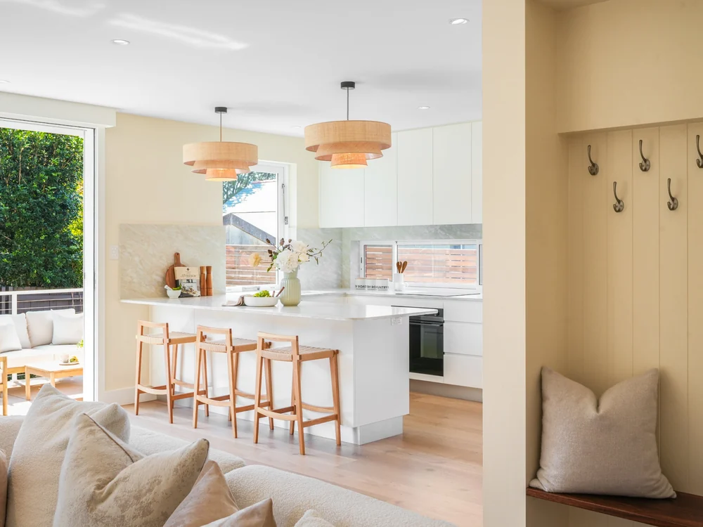 Kitchen seen from the living room, with a built-in bench seat and hooks in the hall, 27 Forsyth Street