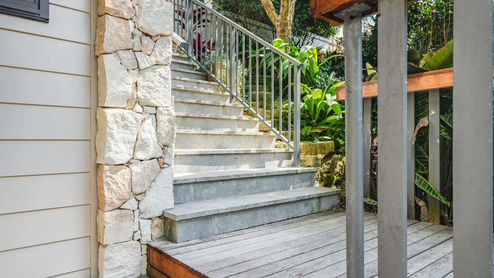 Stone wall and concrete stair rising to the entry deck, Mosman